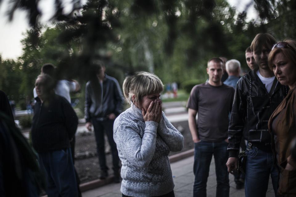 A woman reacts after Ukrainian national guardsmen opened fire on a crowd outside a town hall in Krasnoarmeisk, about 30 kilometers (20 miles) from the regional capital, Donetsk, Ukraine, Sunday, May 11, 2014. Although the voting in the Donetsk and Luhansk regions appeared mostly peaceful, Ukrainian national guardsmen opened fire on a crowd outside a town hall in Krasnoarmeisk, and an official with the region’s insurgents said there were fatalities. (AP Photo/Manu Brabo)