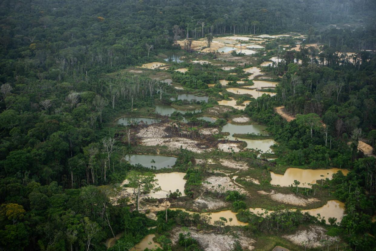 <span>Sprawling into both traditional Saamaka lands and areas overlapping with logging concessions, wildcat illegal gold mining projects exacerbate tensions and threaten the environment.</span><span>Photograph: Bram Ebus/The Guardian</span>