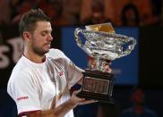 Stanislas Wawrinka of Switzerland poses with Norman Brookes Challenge Cup after defeating Rafael Nadal of Spain in their men's singles final match at the Australian Open 2014 tennis tournament in Melbourne January 26, 2014. REUTERS/Petar Kujundzic