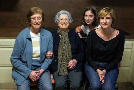 Pilar Fernandez (2nd L), 101, poses for a portrait in the kitchen of her home with her daughter Pili (L), granddaughter Flori (R) and her great granddaughter Ana in Ambas, Asturias, northern Spain, October 18, 2016. REUTERS/Andrea Comas/Files