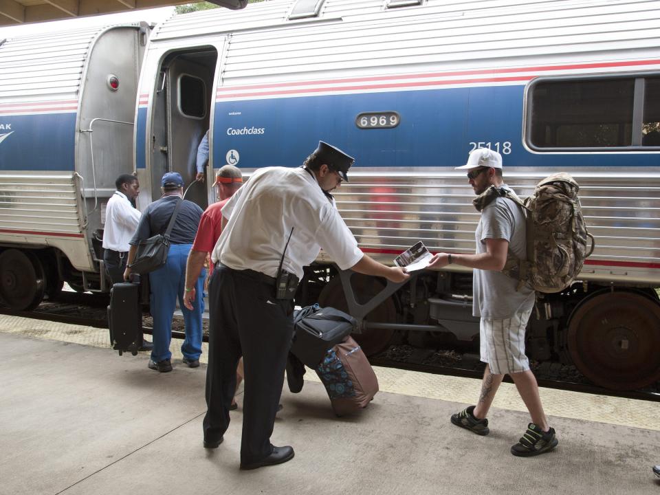 amtrak attendant checking tickets outside of train