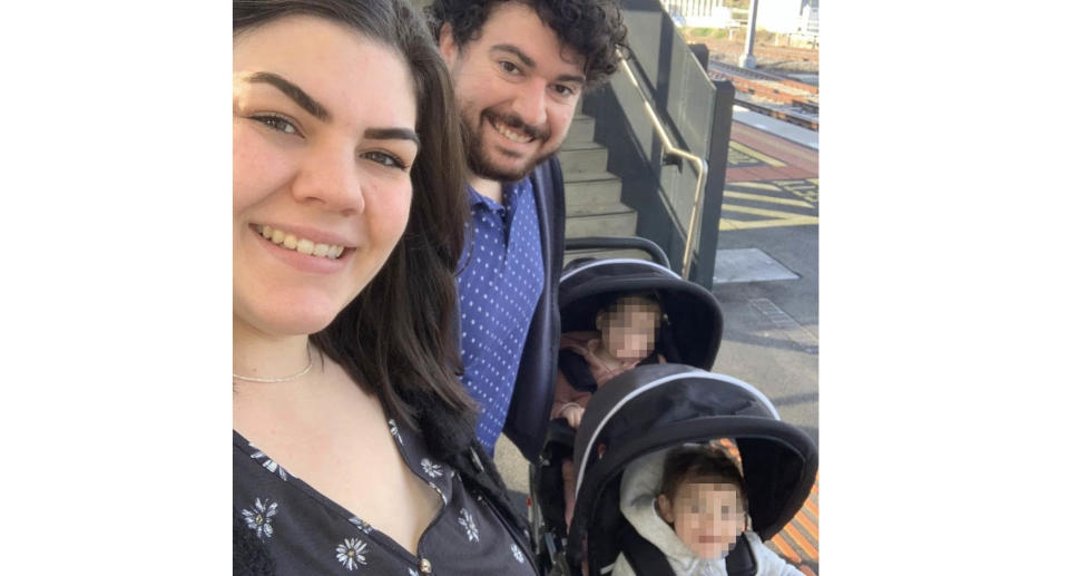 Joe and Amber Powell with their two children in a pram.