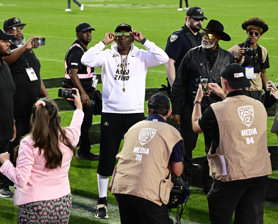 BOULDER, CO - SEPTEMBER 16: Colorado Buffaloes head coach Deion Sanders shows off his sunglasses to the fans during his traditional walk around the field before the Rocky Mountain Showdown against the CSU Rams at Folsom Field September 16, 2023. (Photo by Andy Cross/MediaNews Group/The Denver Post via Getty Images)