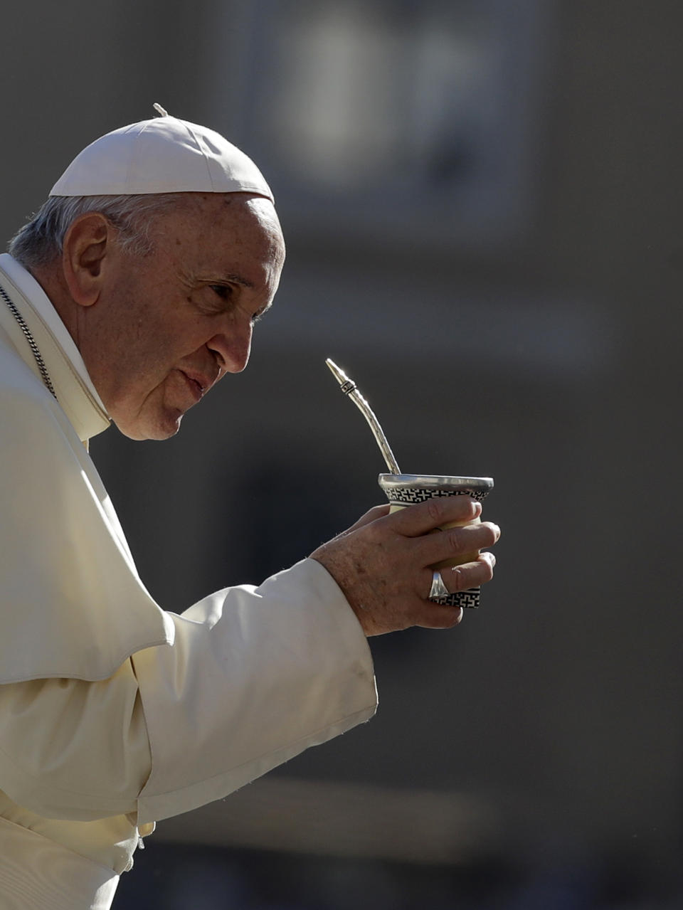 Pope Francis drinks mate offered by a pilgrim as he arrives in St. Peter's Square at the Vatican for his weekly general audience, Wednesday, Sept. 12, 2018. (AP Photo/Alessandra Tarantino)