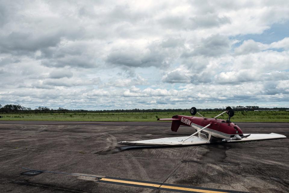 A single-engine airplane is flipped on its roof at the Perry-Foley Municipal Airport in Perry, Fla., following Hurricane Idalia's landfall in Keaton Beach Wednesday morning, Aug. 30, 2023.