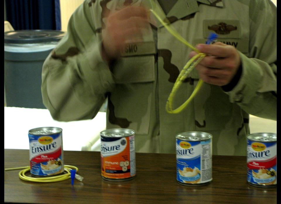 Photo reviewed by U.S. military officials shows a senior medical officer demonstrating how the detainees who refuse to eat are fed with a feeding tube in the hospital of the Guantanamo Bay Camp VI in Guantanamo. (Virginie Montet/AFP/Getty Images)