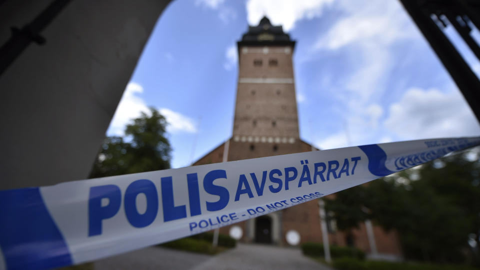 In this Tuesday, July 31, 2018 photo, a police cordon near the scene of a robbery at the Strangnas Cathedral, in Strangnas, Sweden. Police say thieves have stolen priceless treasures from the Swedish royal regalia, including a jeweled crown, from a cathedral where they were on display, before speeding off by motorboat. (Pontus Stenberg/TT News Agency via AP)