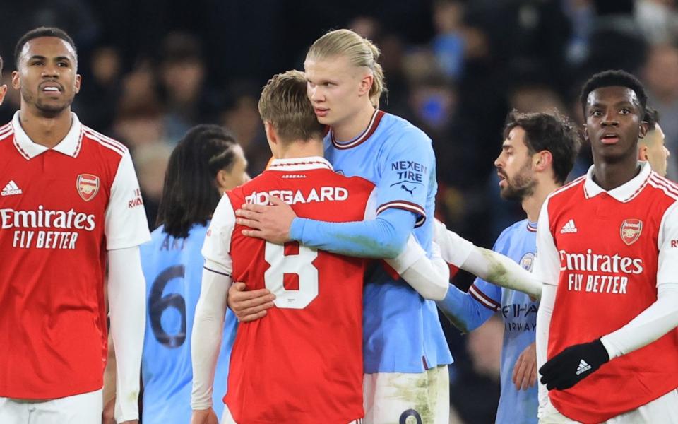 Arsenal players look dejected as Martin Odegaard of Arsenal hugs Erling Haaland of Manchester City during the Emirates FA Cup Fourth Round match between Manchester City and Arsenal at Etihad Stadium on January 27, 2023 in Manchester, England - Getty Images/Simon Stacpoole