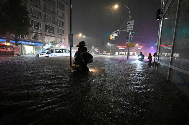 PHOTO: In this Sept. 1, 2021, file photo, members of the FDNY wade through waist high water caused by flash flooding brought by the remnants of hurricane Ida, in the New York City borough of Queens, N.Y. (Anthony Behar/Sipa USA via AP, FILE)