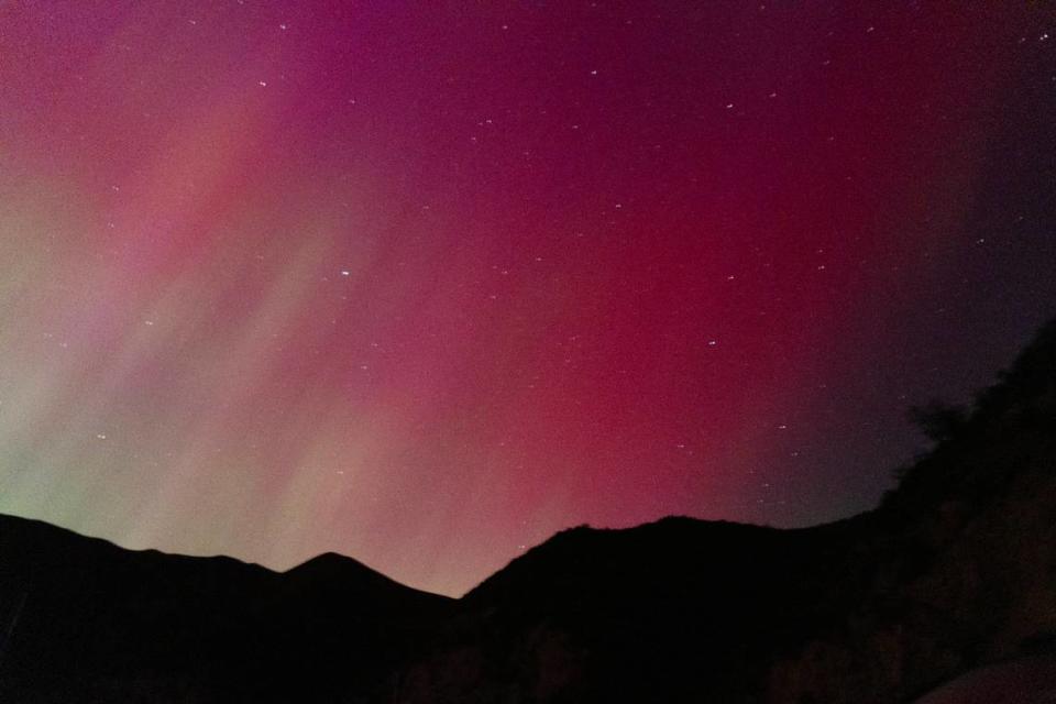 The northern lights appear north of Lucky Peak State Park near Boise, Friday, May 10, 2024. The phenomenon was made possible by a large solar storm interacting with the Earth’s magnetic field, creating glowing atmospheric gases.