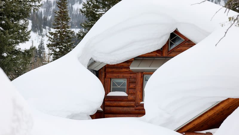 A house is buried in snow in Brighton on Monday, March 13, 2023.