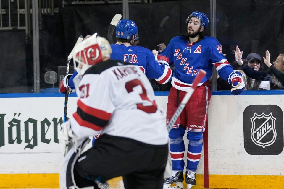 New York Rangers' Mika Zibanejad, right, celebrates after scoring on New Jersey Devils goaltender Kaapo Kahkonen (31) during the second period of an NHL hockey game, Monday, March 11, 2024, in New York.