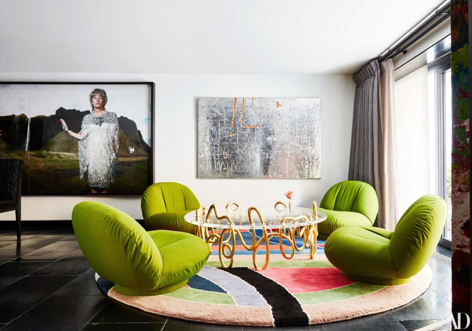 A vintage Frank Stella rug decorates a seating area. Photograph (left) by Cindy Sherman; artwork (right) by Rudolf Stingel.