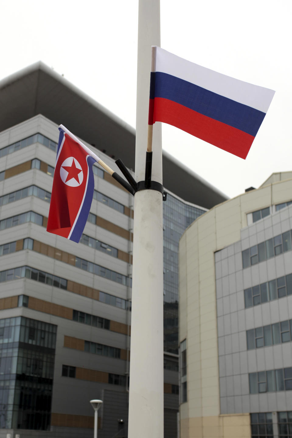 Flags of Russia, right, and North Korea are seen along the road on Russky Island, in Vladivostok, Russia, Tuesday, April 23, 2019. Russian President Vladimir Putin will meet with North Korean leader Kim Jong Un for a much-anticipated summit on upcoming Thursday, a Kremlin adviser said, putting an end to weeks of speculation about when and where it would take place. (AP Photo/Anton Iankovski)