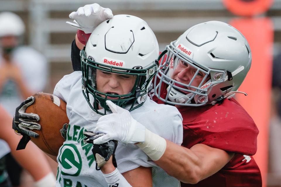 Dover's David Denney makes a tackle during the scrimmage against GlenOak, Saturday, Aug. 6 at Crater Stadium.