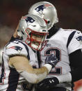 New England Patriots running back Rex Burkhead (34) celebrates a touchdown with quarterback Tom Brady (12)during the second half of the AFC Championship NFL football game against the Kansas City Chiefs, Sunday, Jan. 20, 2019, in Kansas City, Mo. (AP Photo/Jeff Roberson)