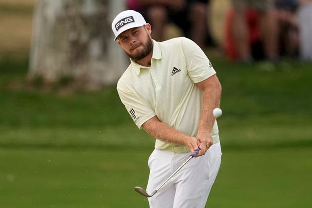 Tyrrell Hatton, of England, chips to the green on the 18th hole 