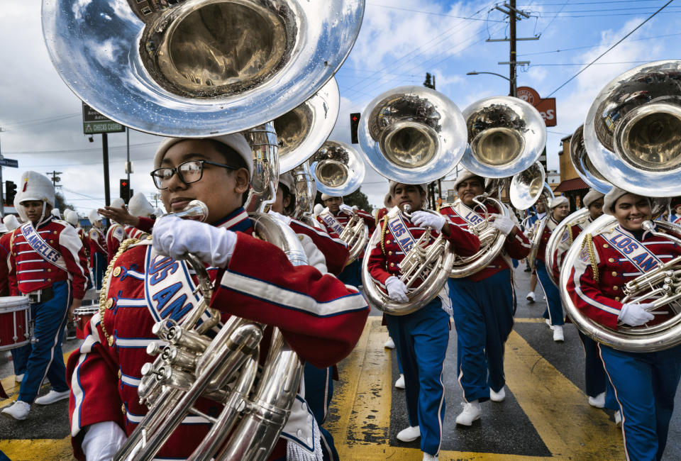 The Los Angeles Unified School District All District High School Honor Band Tuba section join the parade route to participate in the Kingdom Day Parade in Los Angeles, Monday, Jan. 16, 2023. After a two-year hiatus because of the COVID-19 pandemic, the parade, America's largest Martin Luther King Day celebration returned. (AP Photo/Richard Vogel)