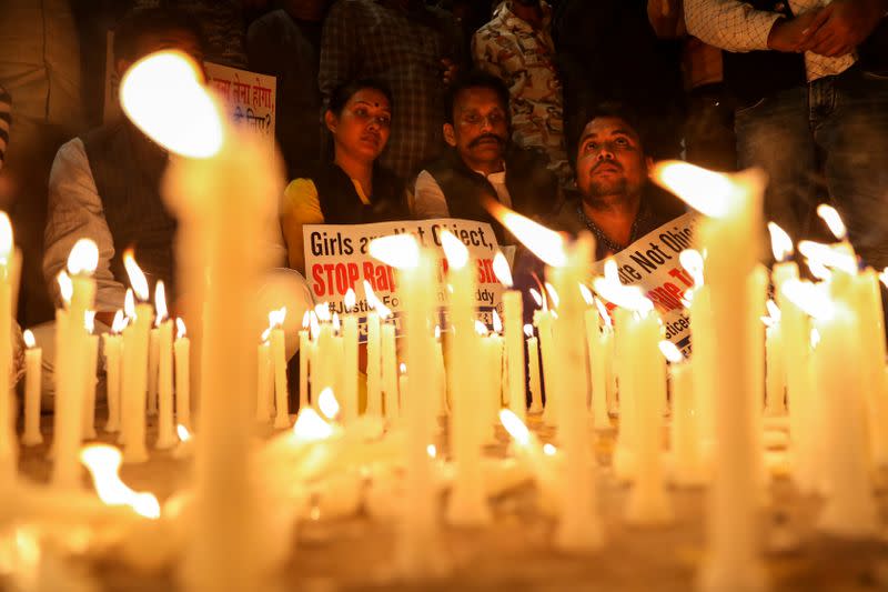 People attend a candle light march to protest against the alleged rape and murder of a 27-year-old woman on the outskirts of Hyderabad, in New Delhi