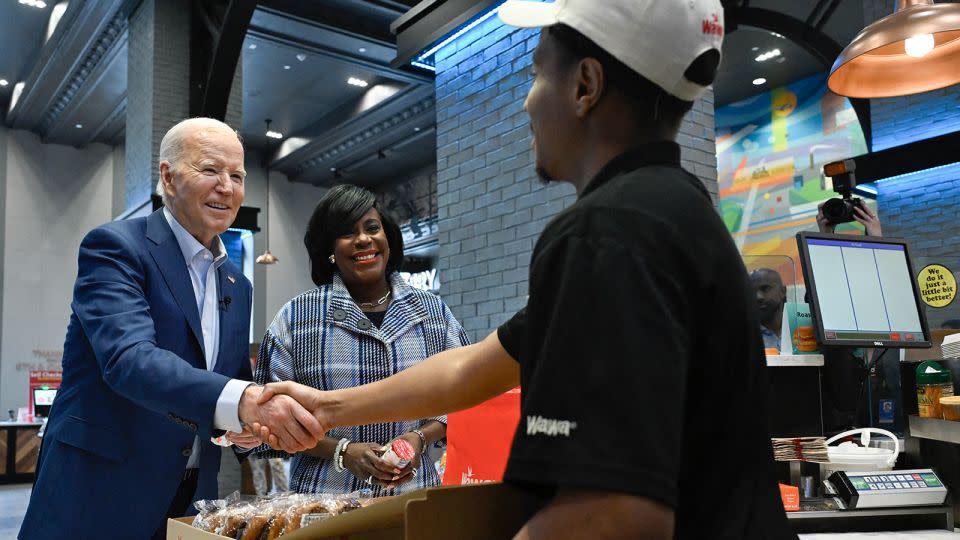 President Joe Biden shakes hands with an employee after ordering sandwiches at a Wawa store in Philadelphia on April 18, 2024. - Andrew CAballero-Reynolds/AFP/Getty Images