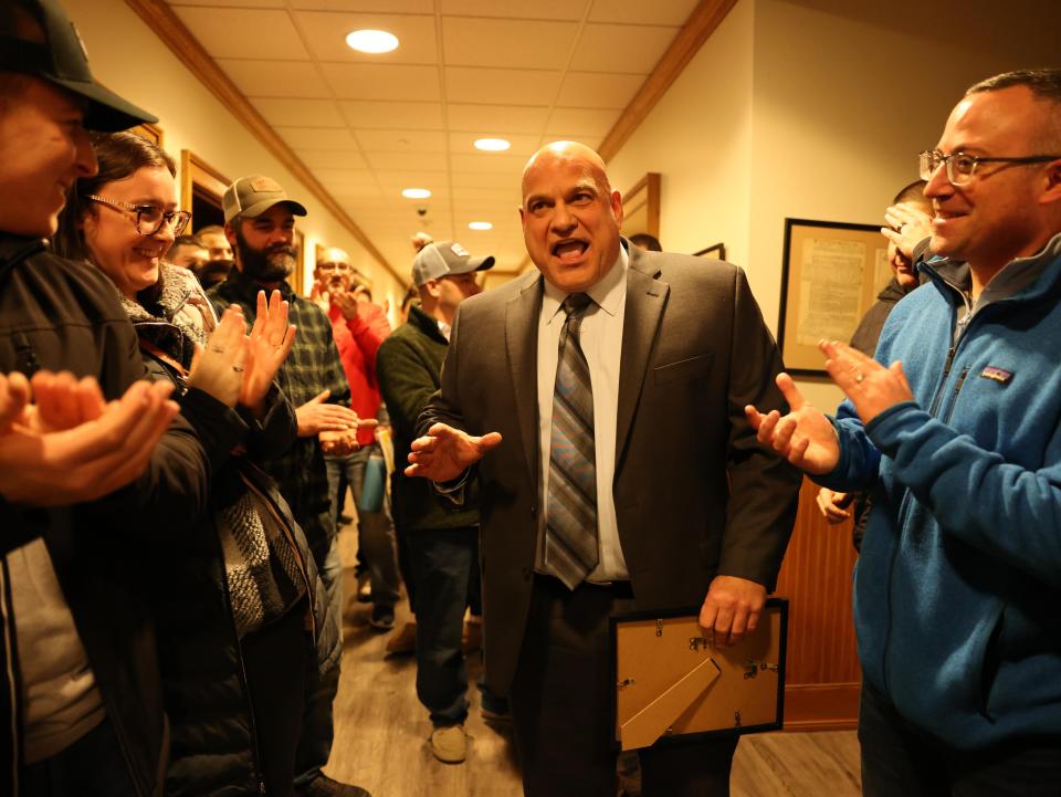 Raynham Selectmen presented the "Raynham Recognition Award" to Police Det. Louis F. Pacheco, center, at Town Hall on Tuesday, Jan. 23, 2024. Pacheco is the Raynham school resource officer and B-R head football coach.