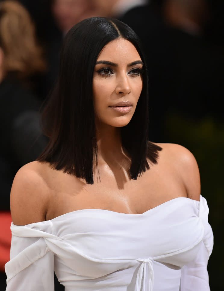 Kim Kardashian rarely smiles in photos to avoid wrinkles. (Photo: Getty Images)