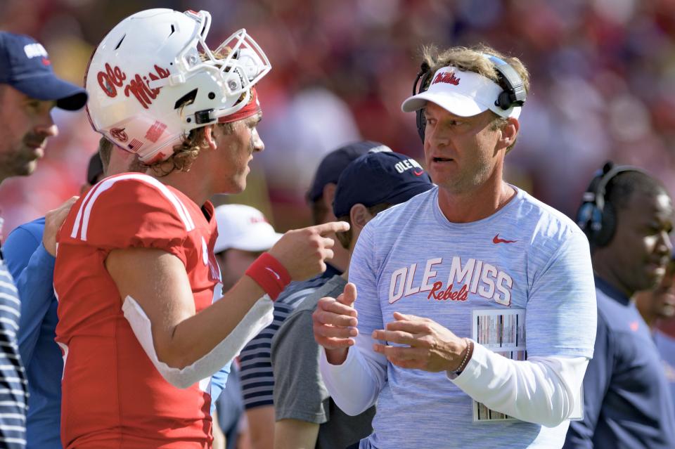 Mississippi head coach Lane Kiffin talks to Mississippi quarterback Jaxson Dart (2) during the first half an NCAA college football game against LSU in Baton Rouge, La., Saturday, Oct. 22, 2022. (AP Photo/Matthew Hinton)