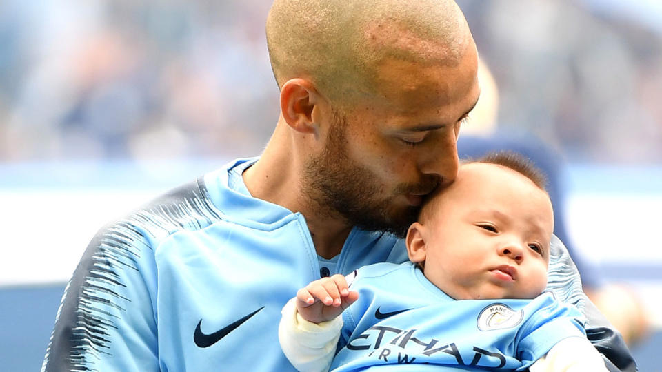 David Silva kisses his son Mateo on the head prior to Manchester City’s EPL fixture with Huddersfield. Pic: Getty