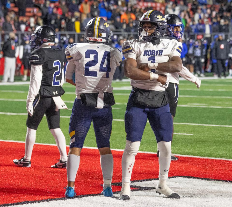 Toms River North's Micah Ford (right) and teammate Josh Moore celebrate a touchdown in the Mariners' 23-13 win over Passaic Tech in the NJSIAA Group 5 championship game.