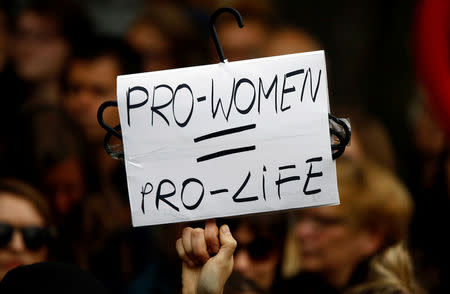 A woman holds a placard as she takes part in a "Black Protest" in front of the Parliament in Warsaw, Poland. REUTERS/Kacper Pempel