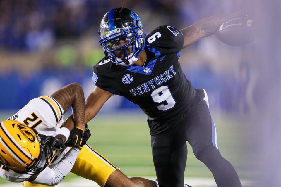 Kentucky wideout Tayvion Robinson tries to break a tackle against Missouri on Saturday.