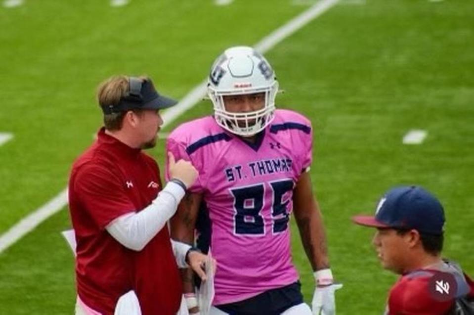 St. Thomas University wide receivers/tight ends coach Drew Davis talks to one of his players during a recent game.