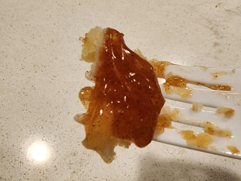 A plastic fork with a dollop of pie filling on it