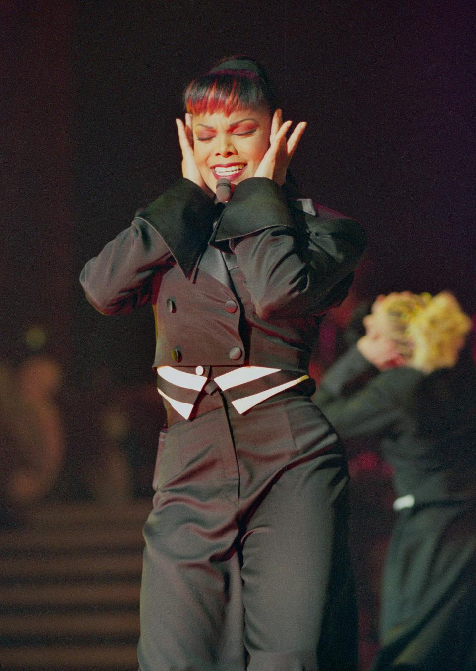 Janet Jackson performs on stage in 1998.