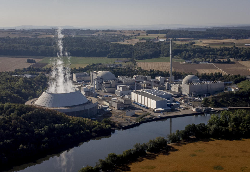 FILE -- Water vapor rises from the cooling tower of nuclear power plant of Neckarwestheim in Neckarwestheim, Germany, Aug. 22, 2022. The German government has dismissed calls Wednesday for another last-minute delay of the long-planned shutdown of the country's last three nuclear power plants this weekend. (AP Photo/Michael Probst,file)