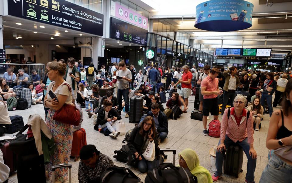 Passengers wait for their train departures at the Gare Montparnasse in Paris