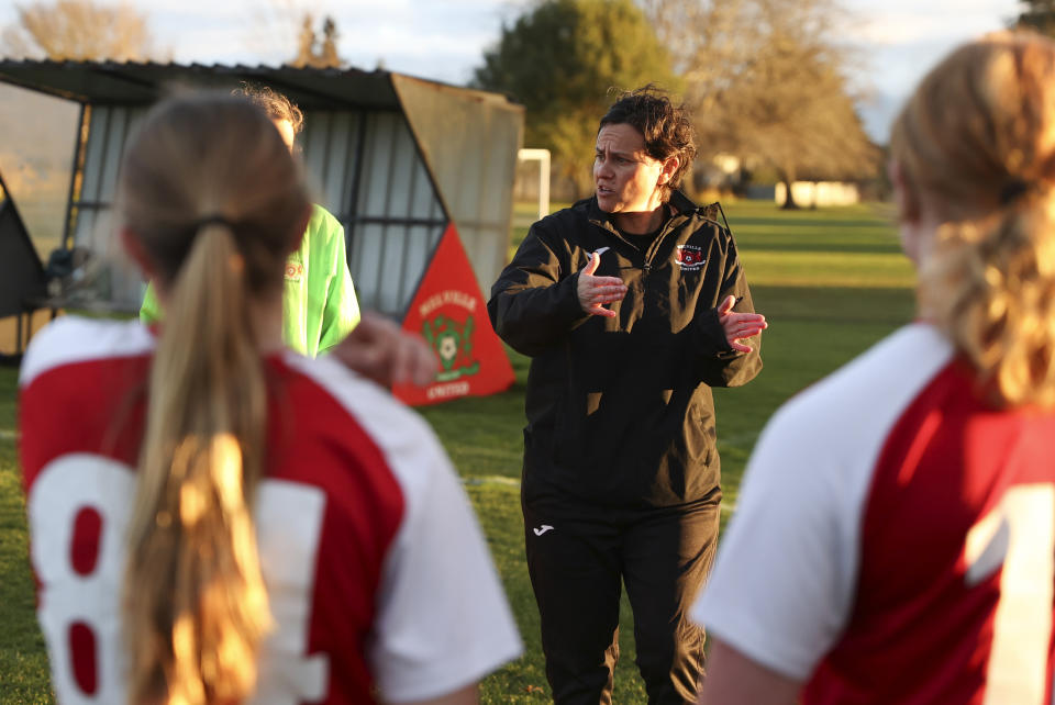 Melville United AFC head of women's football Tarena Ranui gestures to players ahead of a girls soccer match at Gower Park in Hamilton, New Zealand, Monday, July 24, 2023. Ranui, a Maori youth coach, is among those leading the charge to change the landscape of soccer in New Zealand. (AP Photo/Luke Vargas)