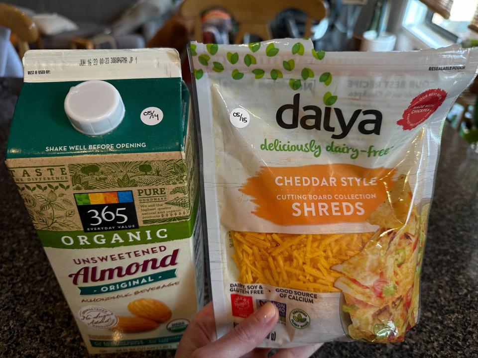 Almond milk and daiya cheese labeled with the date they were opened with stickers