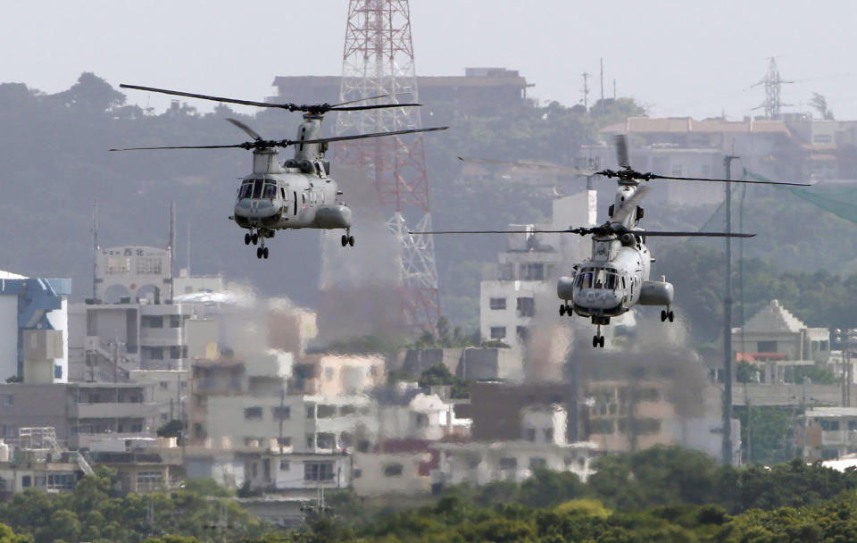 In this Aug. 16, 2012, file photo, CH-46 helicopters take off from the U.S. Marine Corps base in Futenma, in Okinawa, Japan. President Donald Trump is raising a large chunk of the money for his border wall with Mexico by deferring several large military construction projects slated for the strategically important Pacific outpost of Guam. This may disrupt plans to move Marines to Guam from Japan and to modernize important munitions storage for the Air Force. About 7% of the funds for the $3.6 billion wall are being diverted from eight projects in U.S. territory.(AP Photo/Greg Baker, File)
