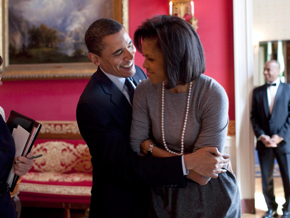 Barack and Michelle Obama embrace in the Red Room of the White House.