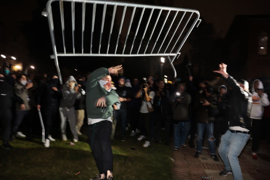 LOS ANGELES, CALIFORNIA – May 1: Pro-Palestinian protestors and pro-Israeli supporters clash at an encampment at UCLA early Wednesday morning. (Wally Skalij/Los Angeles Times via Getty Images)
