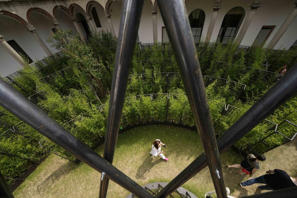 Visitors enjoy 'Labyrinth garden' by Raffaello Galliotto designer, for Nardi outdoor, part of the 'Fuorisalone', during the Design Fair exhibition, at the Statale University courtyard, in Milan, Italy, Wednesday, June 8, 2022. The Milan furniture and design week fair is a six-day event which ends next Sunday. (AP Photo/Luca Bruno)