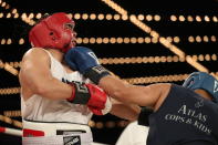 <p>Robert Cruz (red) gets a wake-up call from Johnny Orellano (blue) in the Executive Decision Match during the NYPD Boxing Championships at the Hulu Theater at Madison Square Garden on March 15, 2018. (Gordon Donovan/Yahoo News) </p>