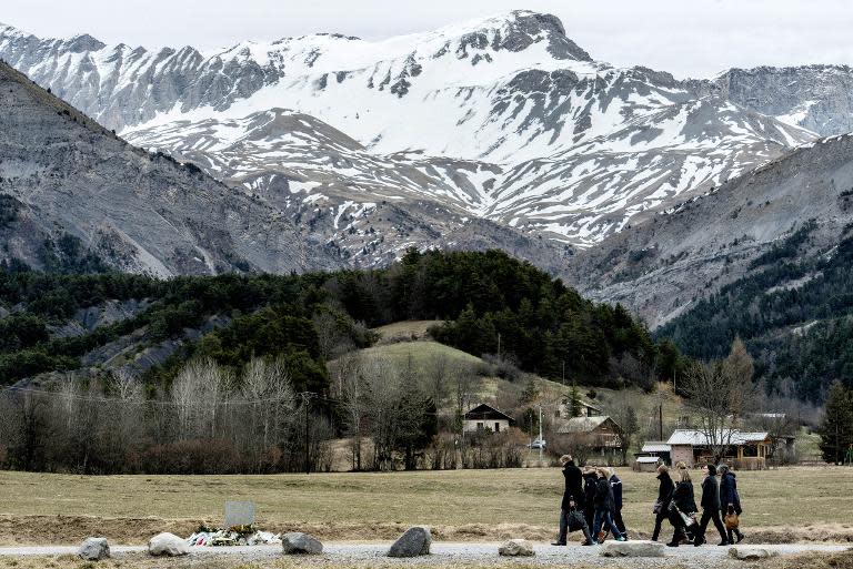 People arrive to pay tribute to the victims of a Germanwings flight that crashed in the French Alps, killing all 150 aboard, on March 28, 2015 at a memorial in le Vernet, south-eastern France, near the site of the crash