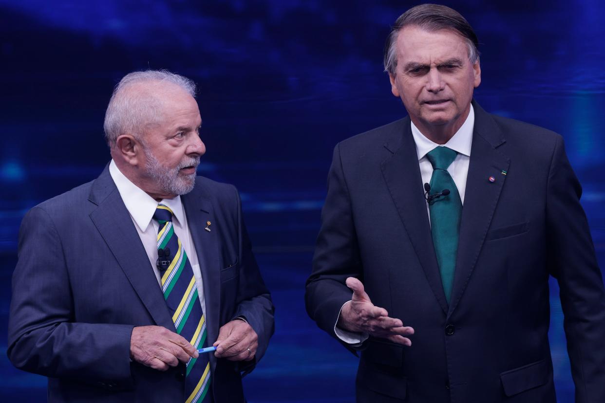 Luiz Inácio Lula Da Silva and Jair Bolsonaro speak to each other during the presidential debate ahead of the run-off on October 16, 2022 in Sao Paulo, Brazil.