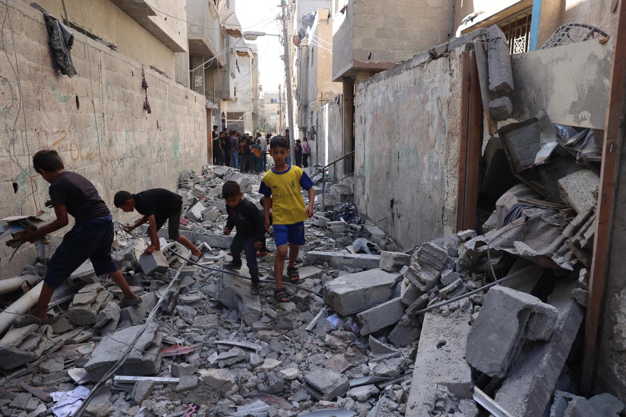 Palestinian children walk through the rubble following Israeli bombardment of Rafah’s Tal al-Sultan district in the southern Gaza Strip on Tuesday (AFP via Getty Images)