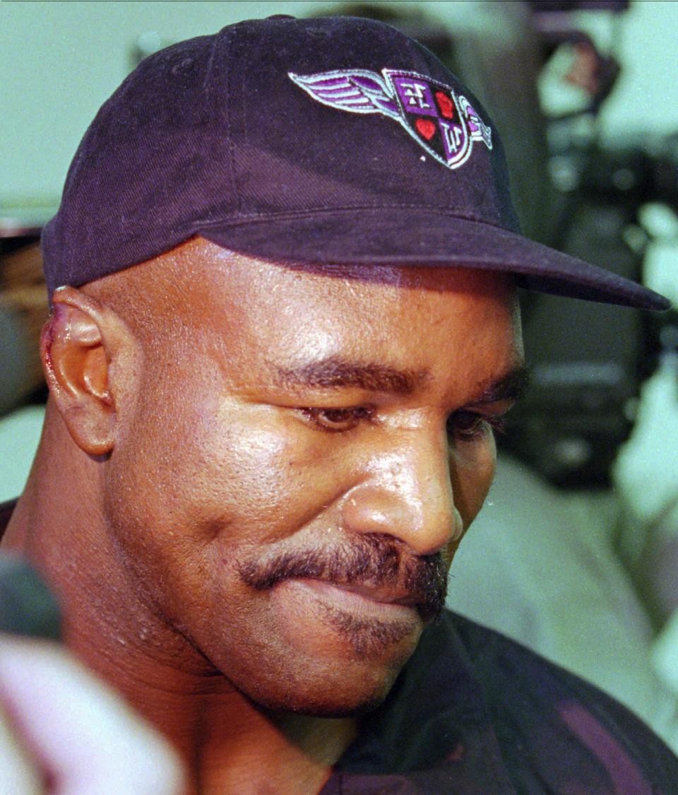 <p>WBA Heavyweight champion Evander Holyfield talks to the media after having his ear sewn at Valley Hospital in Las Vegas, June 28, 1997. While defending his WBA title against Mike Tyson, Tyson bit a chunk out of his ear in the third round and was disqualified. (AP Photo/Jack Dempsey) </p>