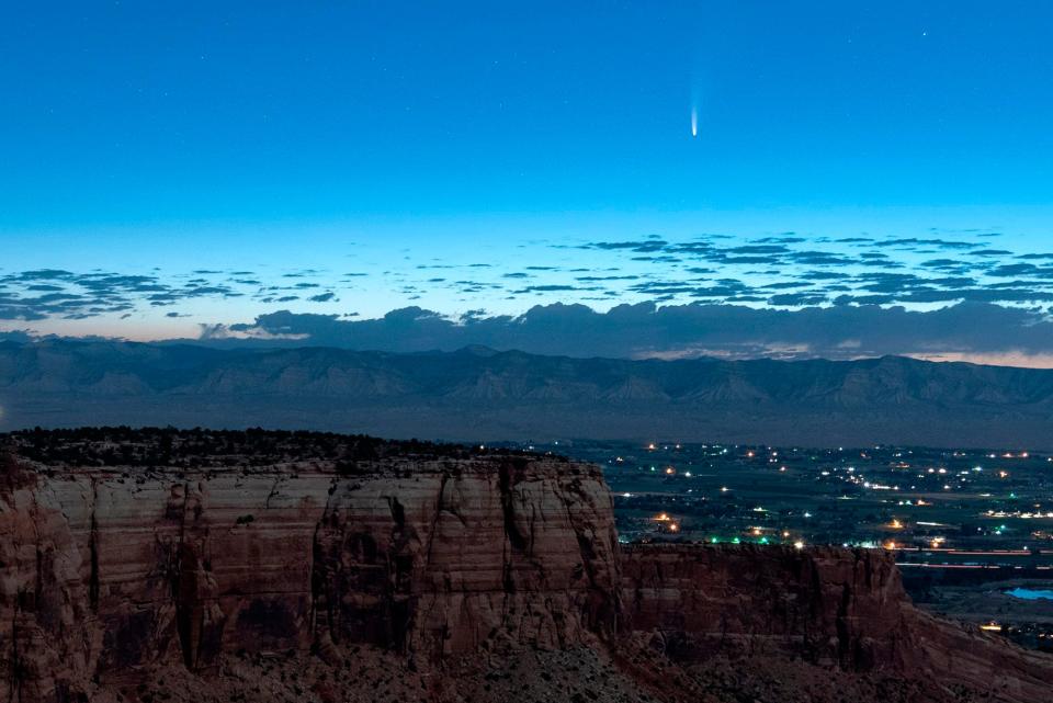 Comet Neowise soars in the horizon of the early morning sky in this view from the near the grand view lookout at the Colorado National Monument west of Grand Junction, Colo., Thursday, July 9, 2020.