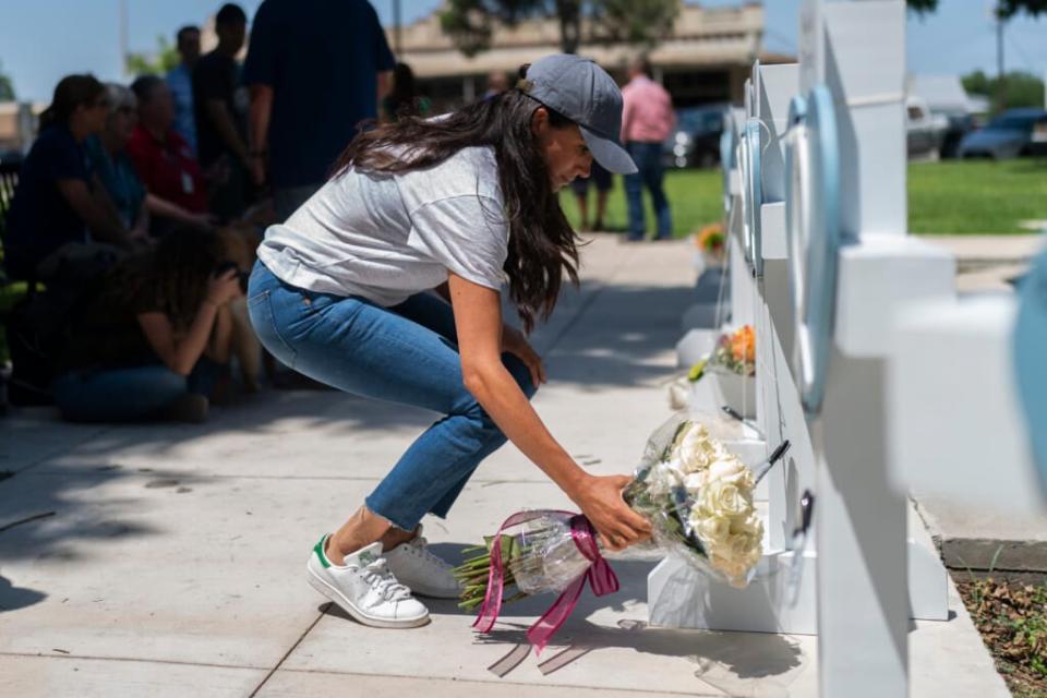 Meghan Markle, Duchess of Sussex, leaves flowers at a memorial site on May 26, 2022 for the victims killed in this week’s elementary school shooting in Uvalde, Texas. (AP Photo/Jae C. Hong)