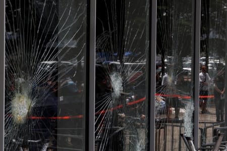 Broken glass is seen at the Legislative Council a day after protesters broke into the building, in Hong Kong